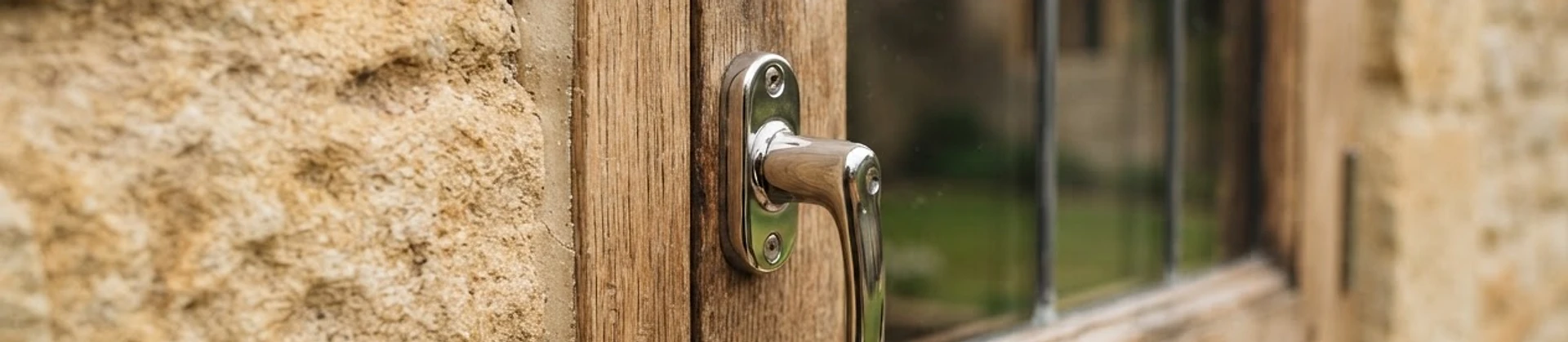 Macro detail of limestone, oak and polished steel on a quality British building facade